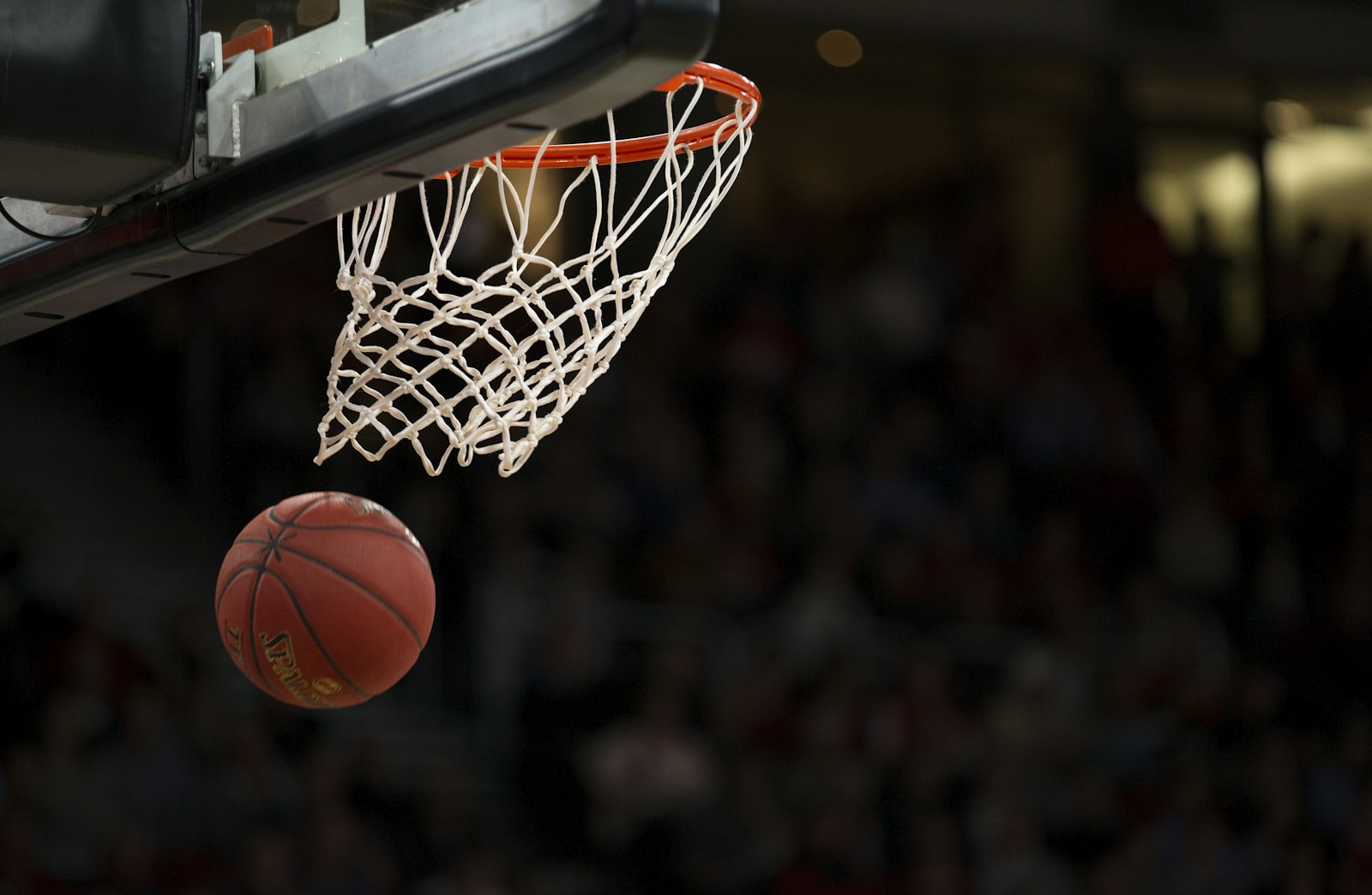Basketball dropping through a hoop