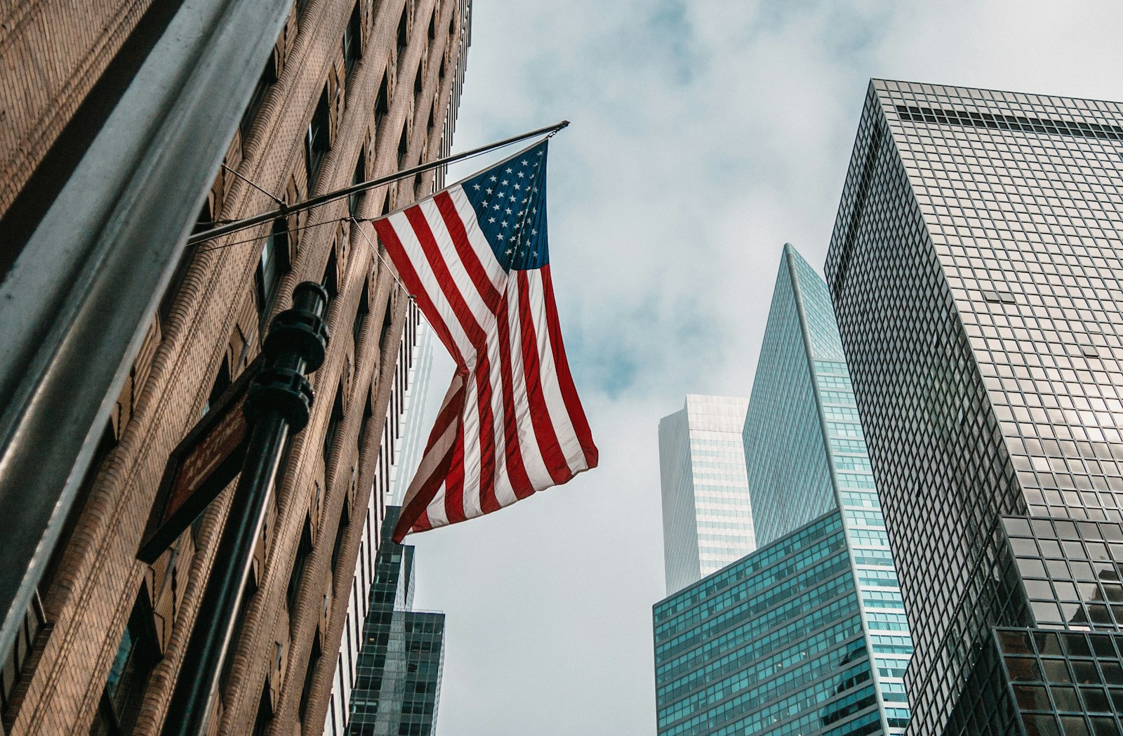American flag flying between buildings